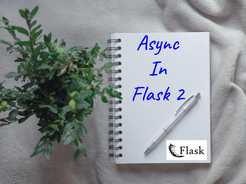Notebook on a table with linen cloth with Async in Flask 2 written on the notebook.